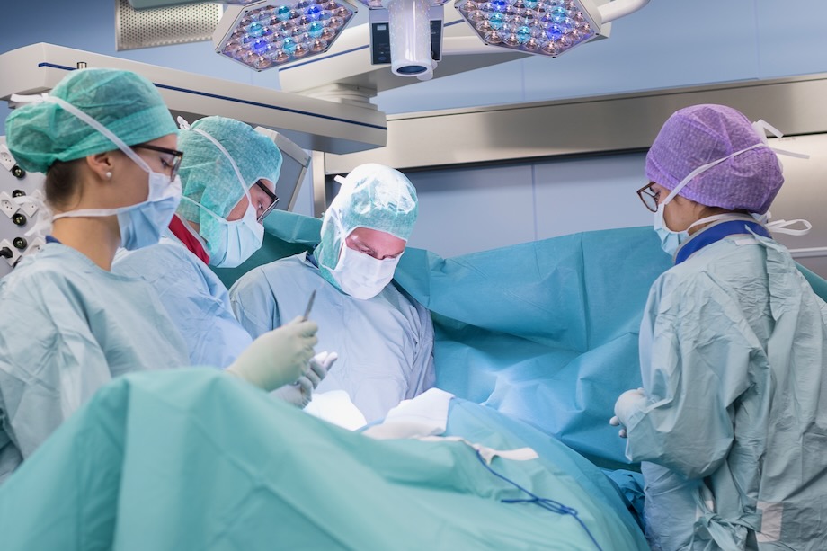 Medical staff in an operating room operating 