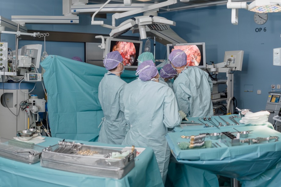 Medical staff in an operating room operating 